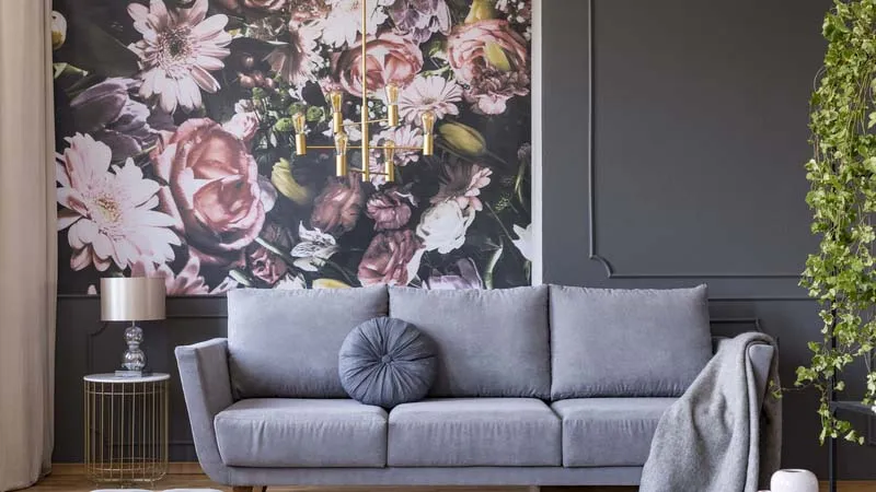 grey living area with pink flowery wallpaper