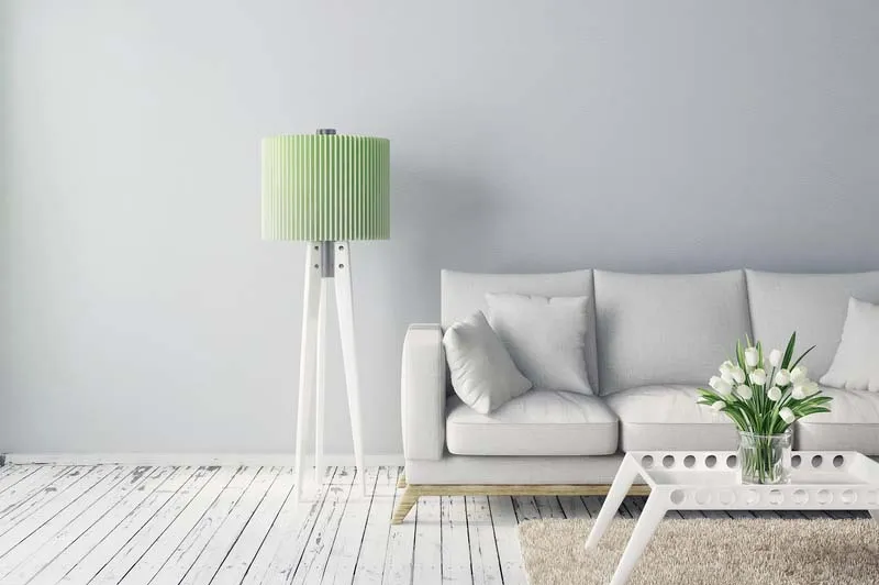 clean, white, minimal living room with pale green accents